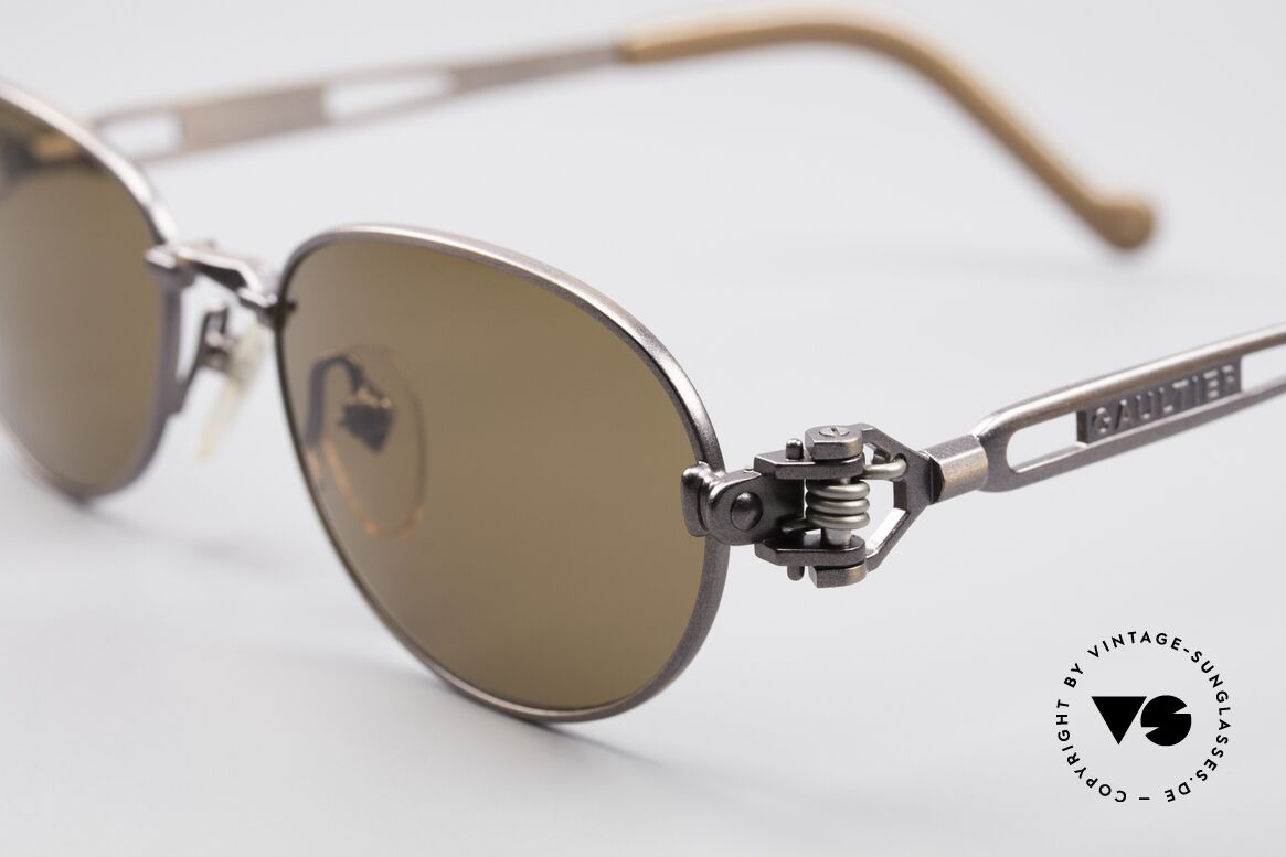Jean Paul Gaultier 56-8102 Oval Steampunk Sunglasses, brownish-metallic; temple ends with a watch symbol, Made for Men and Women