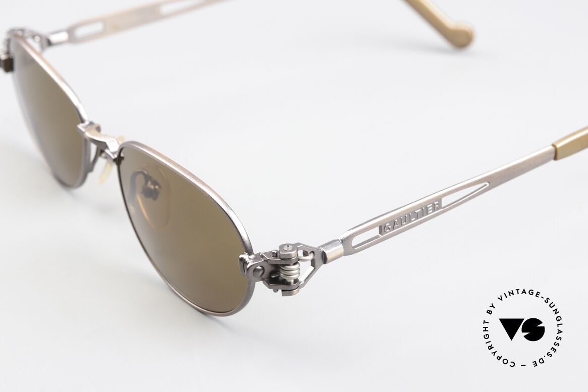 Jean Paul Gaultier 56-8102 Oval Steampunk Sunglasses, brownish-metallic; temple ends with a watch symbol, Made for Men and Women